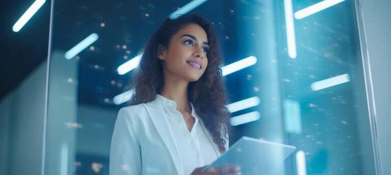 dmcc.aehs-fshubfso2-Website 2023 Assetso2-Website 2023-Design Assetsbusinessimg-woman-looking-out-the-window-holding-a-tablet-2